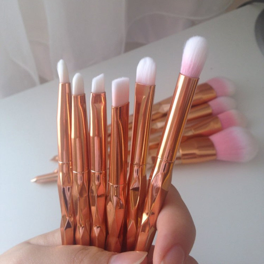 Diamond rose gold makeup brushes with cosmetics”