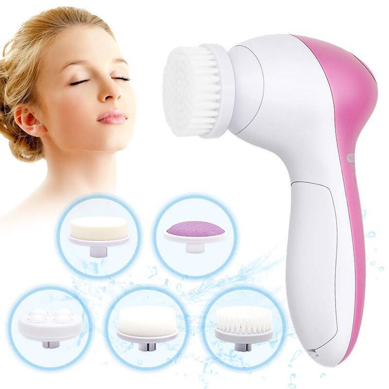 Woman using face massage cleansing brush”