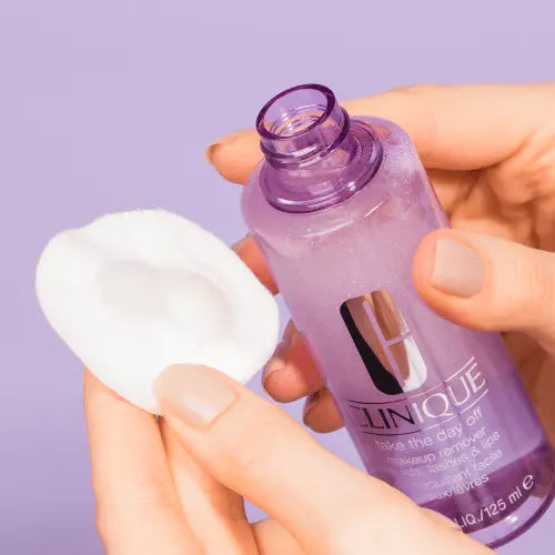 "Clinique gentle eye and lip makeup remover being applied on cotton pad"